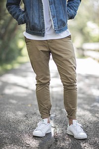 Low shot of a person in white sneakers, khakis, and a denim jacket. Original public domain image from <a href="https://commons.wikimedia.org/wiki/File:Men%27s_Fall_Fashion_(Unsplash).jpg" target="_blank" rel="noopener noreferrer nofollow">Wikimedia Commons</a>