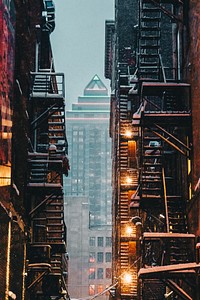 View through an alley of apartment stairwells of a skyscraper downtown in the winter. Original public domain image from Wikimedia Commons