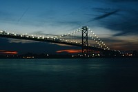 A silhouette of a long bridge at dusk in Windsor, Canada. Original public domain image from Wikimedia Commons