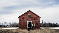 Two people in front of a barn on a winter's day. Original public domain image from <a href="https://commons.wikimedia.org/wiki/File:Barn_(Unsplash).jpg" target="_blank" rel="noopener noreferrer nofollow">Wikimedia Commons</a>