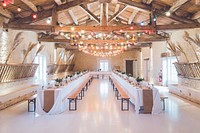 Wedding reception tables with wooden benches and string lights above them at Abbaye de la Grâce-Dieu. Original public domain image from <a href="https://commons.wikimedia.org/wiki/File:Wedding_reception_tables_and_benches_(Unsplash).jpg" target="_blank" rel="noopener noreferrer nofollow">Wikimedia Commons</a>