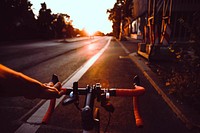 Person riding bicycle on road. Original public domain image from Wikimedia Commons