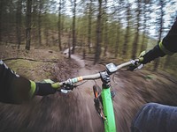 POV shot of the cyclist's hands on the handlebars on a forest trail in Cannock.. Original public domain image from Wikimedia Commons