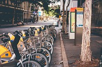 A row of bicycles at a bike-sharing station. Original public domain image from Wikimedia Commons