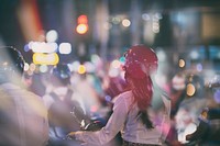 People on motorbikes, wearing helmets at night in Ho Chi Minh City. Original public domain image from Wikimedia Commons