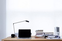 Laptop and lamp on desk with stacks of books and files. Original public domain image from Wikimedia Commons