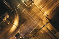 Drone aerial view of worn down asphalt intersection with car light trails and cars at night in Vancouver Lookout. Original public domain image from Wikimedia Commons