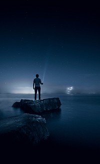 Man holding flashlight. Original public domain image from Wikimedia Commons