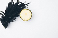 A pineapple sliced in half with the lower-half showing the flesh.. Original public domain image from <a href="https://commons.wikimedia.org/wiki/File:Pineapple_in_half_(Unsplash).jpg" target="_blank" rel="noopener noreferrer nofollow">Wikimedia Commons</a>