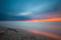 Tree chunk on sunset beach. Original public domain image from Wikimedia Commons