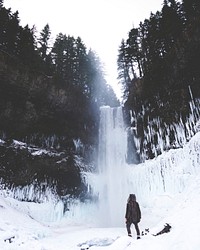 A person staring at the bottom of Brandywine Falls during a snowy winter season. Original public domain image from Wikimedia Commons