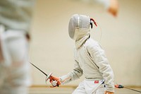 A fencing competition participant in an overexposed shot highlighting the intensity of the competitor's equipment. Original public domain image from Wikimedia Commons