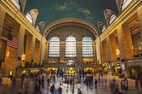 The interior of New York's Grand Central Station with an American flag on one of the walls. Original public domain image from Wikimedia Commons