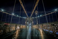The walkway of the Brooklyn Bridge in New York City at night. Original public domain image from Wikimedia Commons