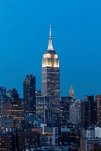 Empire State Building and skyscrapers with lights at night in New York City. Original public domain image from Wikimedia Commons