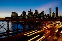 A long-exposure shot of light trails on the freeway with the New York city skyline at the back. Original public domain image from Wikimedia Commons