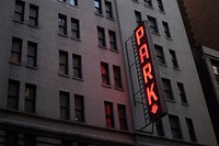 Neon sign reads "PARK" on a dark building in New York. Original public domain image from Wikimedia Commons