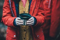 Child wearing raincoat, standing in the cold and holding cup of soup in New Forest District. Original public domain image from Wikimedia Commons