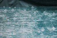 Drops of rain splash and ripple into a blue sea of water in Nederland. Original public domain image from Wikimedia Commons