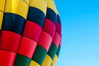 The colorful surface of a hot air balloon against a blue sky. Original public domain image from Wikimedia Commons