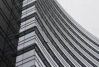 Black and white shot of curved building architecture and windows at Piazza Gae Aulenti. Original public domain image from Wikimedia Commons