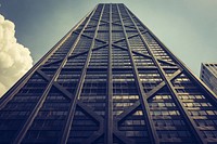 Looking up at a tall dark skyscraper with windows and diagonal and vertical lines. Original public domain image from <a href="https://commons.wikimedia.org/wiki/File:Tall_dark_scyscraper_building_(Unsplash).jpg" target="_blank" rel="noopener noreferrer nofollow">Wikimedia Commons</a>