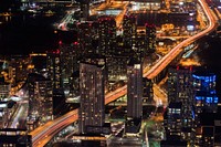 Aerial drone shot of a bustling metropolis at night. Original public domain image from Wikimedia Commons