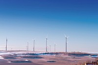 White wind turbine on gray desert under blue and white sky. Original public domain image from <a href="https://commons.wikimedia.org/wiki/File:M%C3%B6lsheim,_Germany_(Unsplash).jpg" target="_blank">Wikimedia Commons</a>