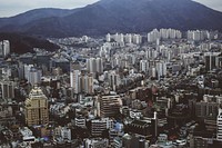 The skyline of Busan and the nearby mountains seen from the Busan Tower. Original public domain image from <a href="https://commons.wikimedia.org/wiki/File:Busan_Tower_cityscape_(Unsplash).jpg" target="_blank" rel="noopener noreferrer nofollow">Wikimedia Commons</a>