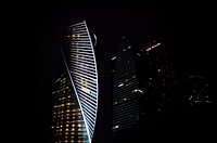 Twisting façades of office buildings in Moscow at night. Original public domain image from <a href="https://commons.wikimedia.org/wiki/File:Twisting_building_facade_(Unsplash).jpg" target="_blank" rel="noopener noreferrer nofollow">Wikimedia Commons</a>