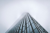 The towering facade of One World Trade Center building shrouded in fog. Original public domain image from Wikimedia Commons