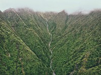 A stream running along a deep mountain valley. Original public domain image from Wikimedia Commons