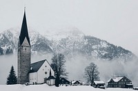 A church during winter in Mittelberg, Austria. Original public domain image from <a href="https://commons.wikimedia.org/wiki/File:Mittelberg,_Austria_(Unsplash).jpg" target="_blank">Wikimedia Commons</a>