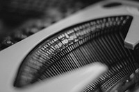 Typebars inside a typewriter in black and white. Original public domain image from Wikimedia Commons