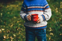 A child holding a red enamel cup with “young, wild and free” written on it. Original public domain image from Wikimedia Commons