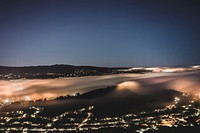 Aerial drone shot of San Bruno Mountains and city lights at night. Original public domain image from Wikimedia Commons