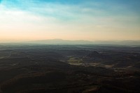 A vast rural landscape with hills crowning the horizon in Riegersburg. Original public domain image from Wikimedia Commons