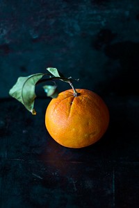 Orange on a black table. Original public domain image from Wikimedia Commons