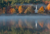 A scenic view of a small church on the shore of a hazy lake in Eaton. Original public domain image from Wikimedia Commons