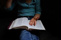 A woman with book on her lap. Original public domain image from Wikimedia Commons