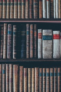 Cropped shot of a antique books on a bookshelf.. Original public domain image from Wikimedia Commons