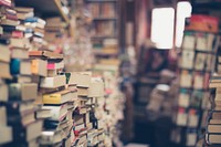 Bookshop with stacks and stacks of old books on the perimeter of the walls. Original public domain image from Wikimedia Commons