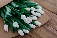 White tulips in bouquets wrapped in brown paper. Original public domain image from <a href="https://commons.wikimedia.org/wiki/File:Roman_Kraft_2016-10-12_(Unsplash).jpg" target="_blank">Wikimedia Commons</a>