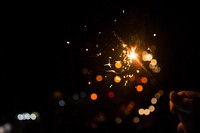 A person holding a sparkler in Mumbai. Original public domain image from Wikimedia Commons