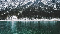 Lake Plansee in Tyrol, Austria, glistens against the backdrop of a snow covered mountain. Original public domain image from <a href="https://commons.wikimedia.org/wiki/File:Day_7_unsplashdaily_(Unsplash).jpg" target="_blank" rel="noopener noreferrer nofollow">Wikimedia Commons</a>