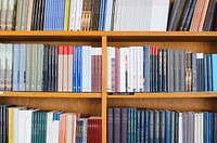 Bookshelf at a library with four shelves at Uppsala University. Original public domain image from Wikimedia Commons