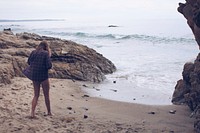 Woman on vacation steps out of the cove to relax in the beach shores. Original public domain image from Wikimedia Commons