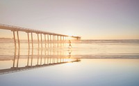 Woman walking on a beach in San Diego, United States. Original public domain image from Wikimedia Commons