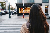 Walking behind a woman about to cross a city street. Original public domain image from Wikimedia Commons