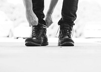 A man tying his shoe laces. Original public domain image from Wikimedia Commons